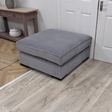The Pillow Top Footstool in Grey with plush cushioned top, versatile design and durable fabric, perfect as a footrest, extra seat or casual coffee table