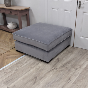 The Pillow Top Footstool in Grey with plush cushioned top, versatile design and durable fabric, perfect as a footrest, extra seat or casual coffee table