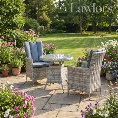 Garden setting with garden furniture set and potted plants on a sunny day.