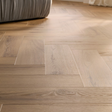 The Rochester Oak Herringbone SPC Flooring features a timeless oak design, suitable for underfloor heating, Titanium Nano finish and a 25 year warranty