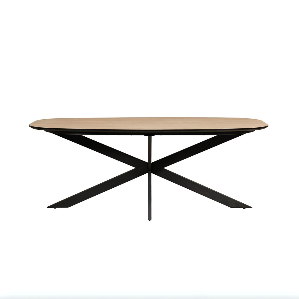 The Sadia Oval Dining Table in Oak features a durable, heat, stain, and scratch-resistant melamine top with a black metal base.