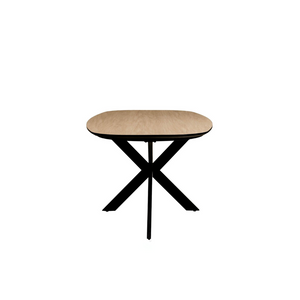 The Sadia Oval Dining Table in Oak features a durable, heat, stain, and scratch-resistant melamine top with a black metal base.