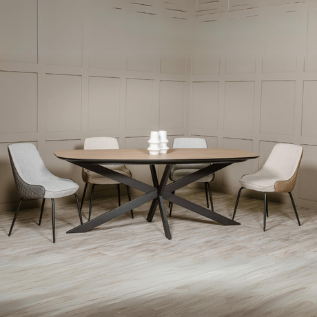 The Sadia Dining Chair in Biscuit features sleek black powder-coated metal legs for sturdy support and modern elegance.