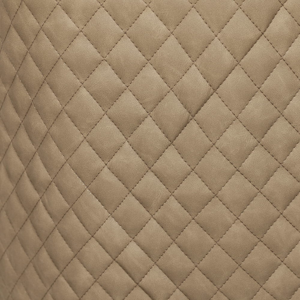 The Sadia Dining Chair in Biscuit features sleek black powder-coated metal legs for sturdy support and modern elegance.