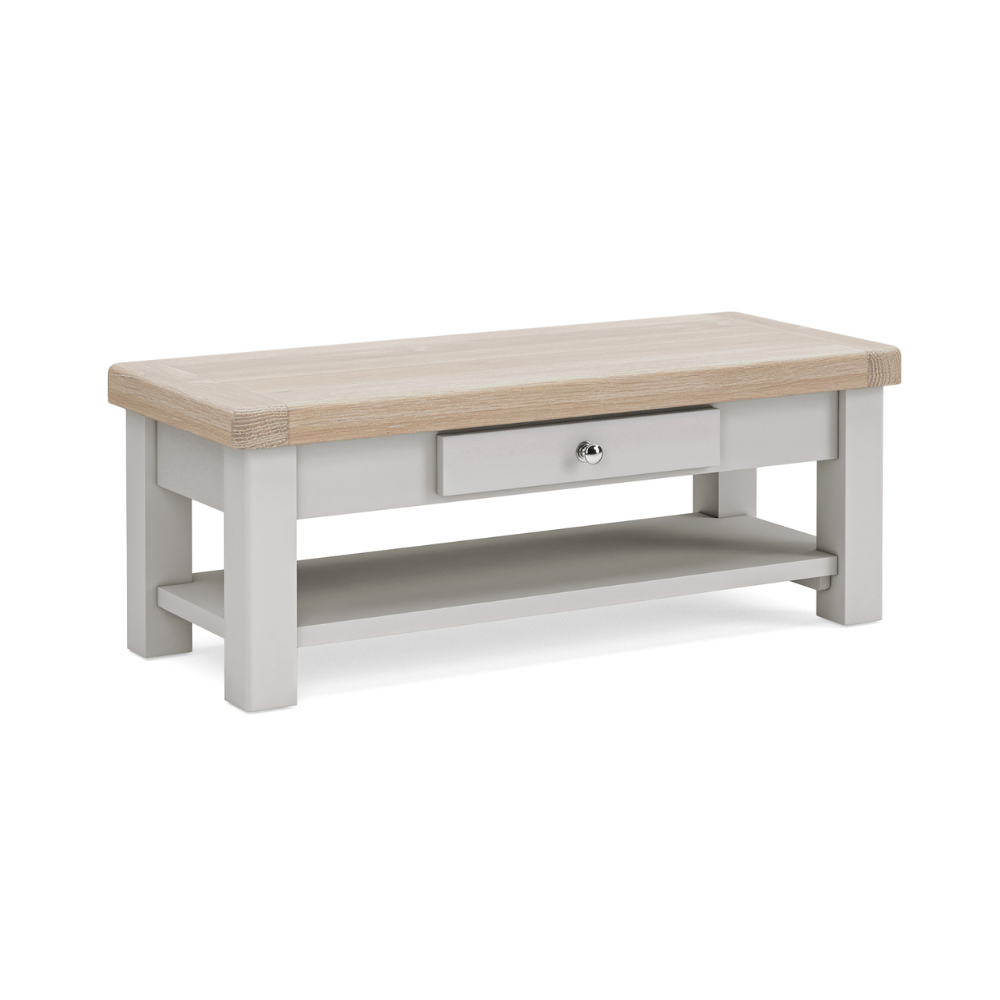 The Salcombe Coffee Table - Light Grey offers a durable oak veneer top, storage drawer, and lower shelf for a modern design.