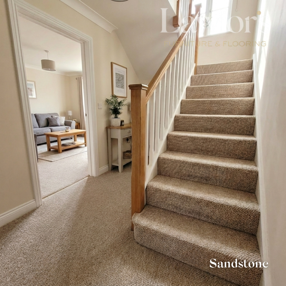 Carpeted staircase with a living room in the background