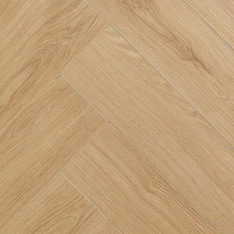 Light oak wood flooring planks arranged in a herringbone pattern, showing natural wood grain textures.