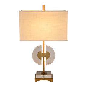 The Shaina Lamp features a circular cut crystal for the base and stem, topped with a rectangular off-white shade