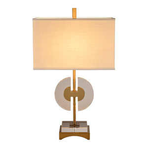 The Shaina Lamp features a circular cut crystal for the base and stem, topped with a rectangular off-white shade