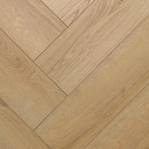Light oak wood flooring planks arranged in a herringbone pattern, showing natural wood grain texture.