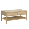 A mid-century modern coffee table made of light natural wood with two drawers and a woven rattan lower shelf, shown on a plain white background.