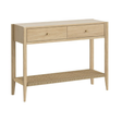 A light oak wood console table with two drawers, small brass knobs, and a woven rattan lower shelf, shown on a plain white background.