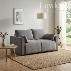 Light grey closed sofa bed in a living room