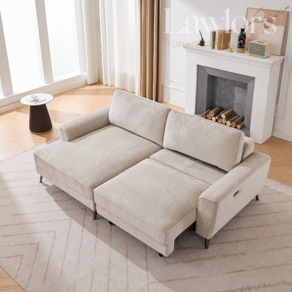 Beige sectional sofa in a living room with a fireplace and decor.