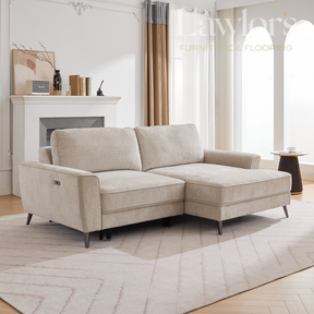 Beige LHF sectional sofa in a living room with a fireplace and large windows.