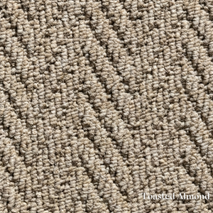 Close-up of textured beige carpet with 'Toasted Almond' label