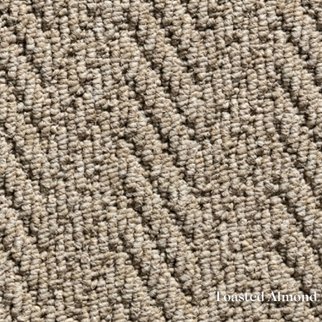 Close-up of textured beige carpet with 'Toasted Almond' label