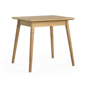 The Valencia Bistro Dining Table in solid oak with tapered legs that is compact, stylish and perfect for cozy dining spaces or breakfast nooks
