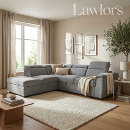 A modern gray L-shaped sectional sofa in a bright, contemporary living room. The sofa is styled with neutral beige and cream pillows and a cream throw blanket.