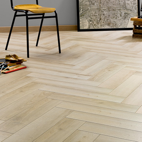 The Vicence Herringbone Laminate Flooring 12mm features AC6-rated oak finish, underfloor heating compatible & herringbone design.