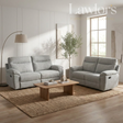 Light grey 3+2 recliner sofa set in a living room with a wooden coffee table and decorative items.
