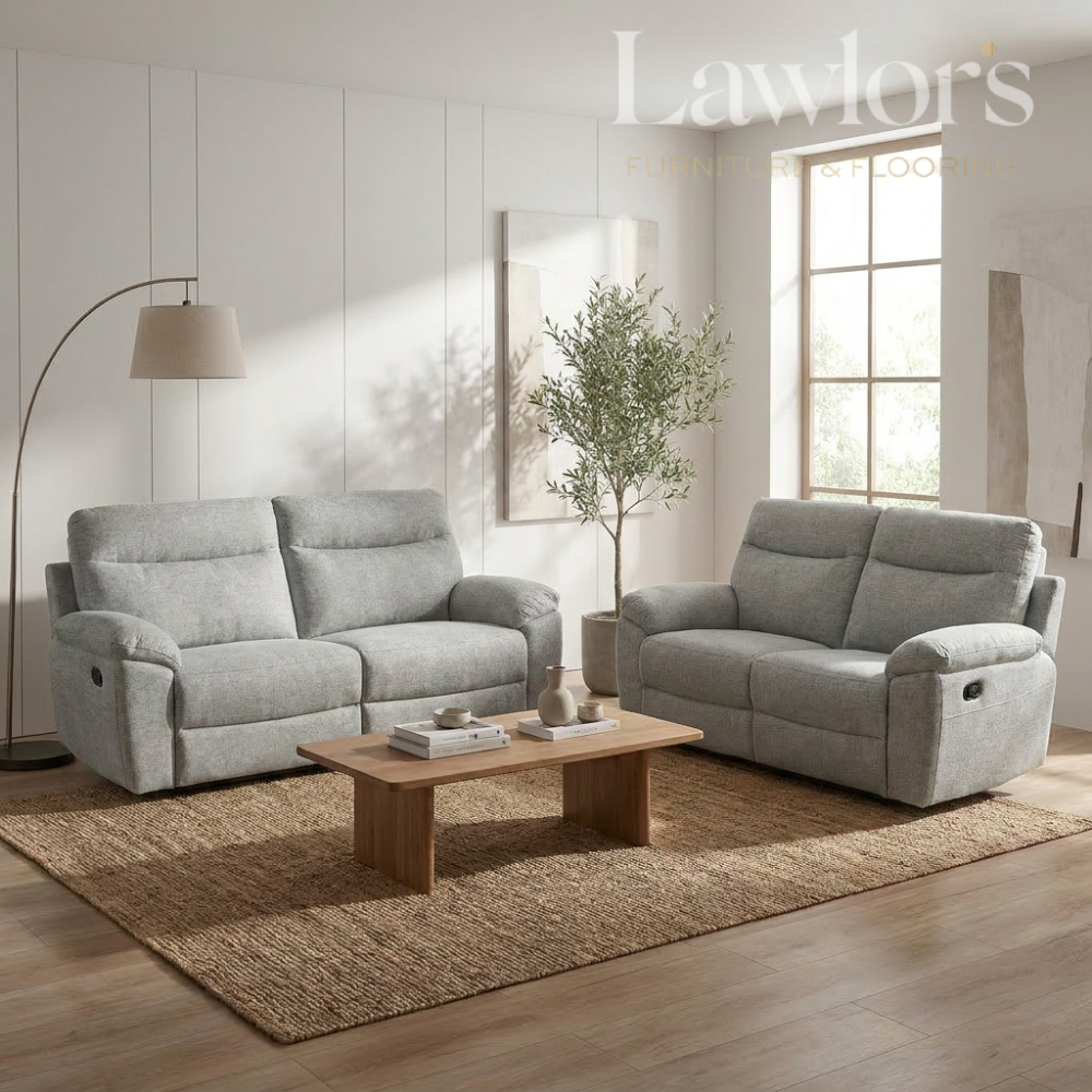Light grey 3+2 recliner sofa set in a living room with a wooden coffee table and decorative items.