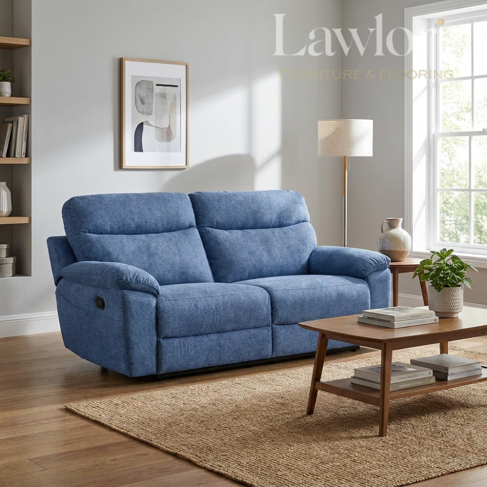 Light blue 3 seater recliner sofa in a living room with a coffee table and decorative items