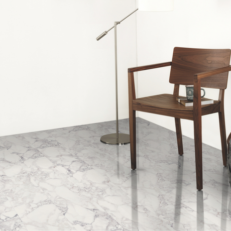 Wooden chair on a marble effect laminate flooring with a white wall background
