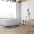 Greige Oak Herringbone Laminate Flooring 12mm: AC4-rated, durable, click-lock installation, suitable for commercial and residential spaces. Timeless herringbone design.