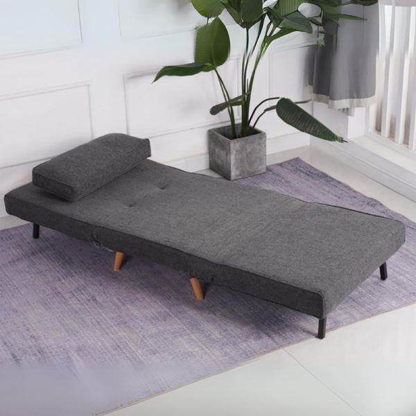 Charcoal single sofa bed with pillow and tapered wooden legs.
